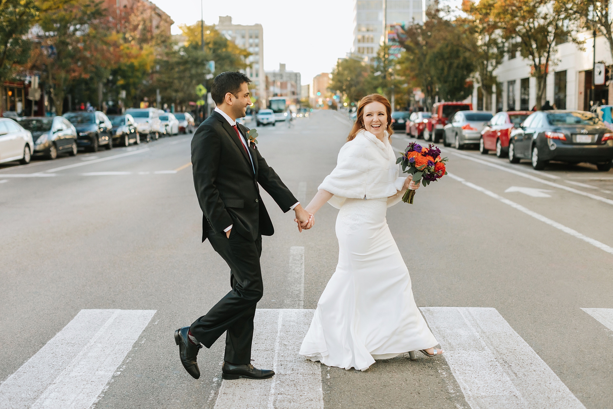 Shannon and Rimal walking across the street on wedding day