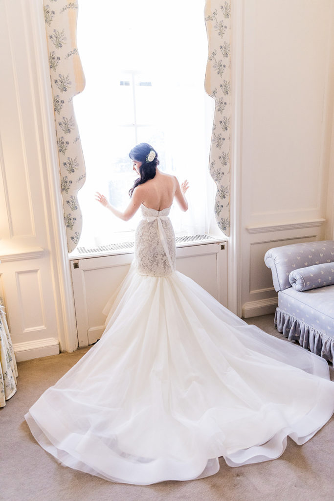 Chelsey looking out the windows with her wedding dress