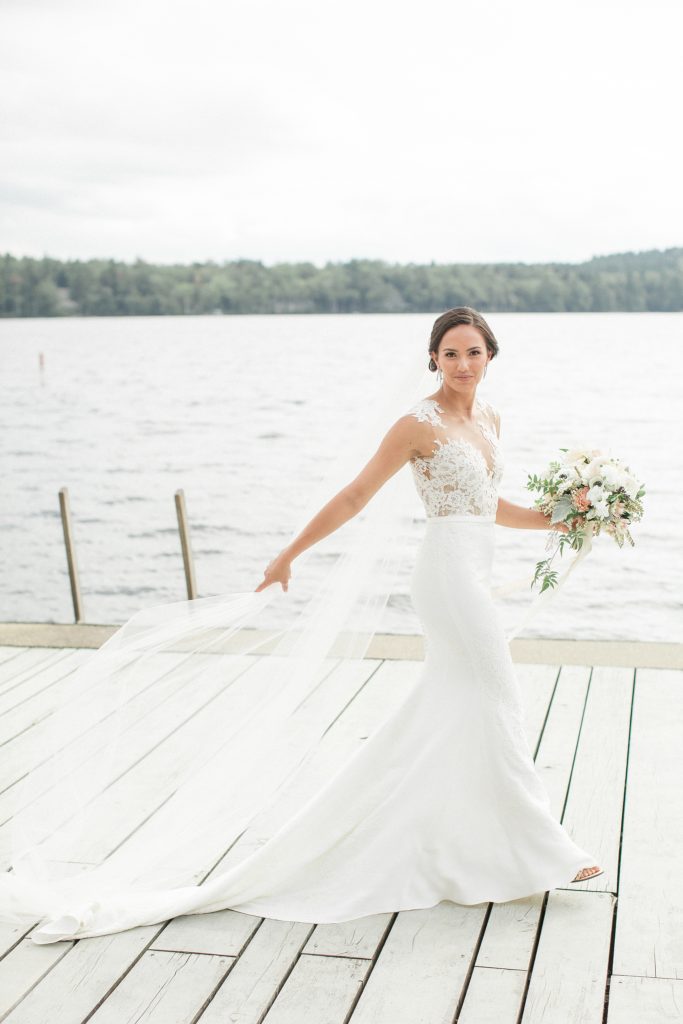Prita and Mac Twin Lake Village wedding walking on dock by the lake